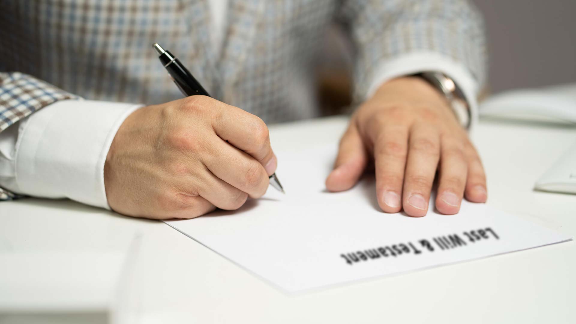 Man about to sign Last Will & Testament